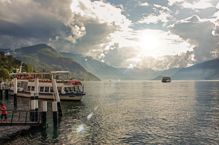 Como, Italy - May 06, 2013. View of Lake Como in a cloudy day with boat in the foreground in Bellagio a charming village between the lake and the mountains of Alps. Lombardy region, northern Italyのeditorial素材
