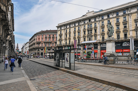 Milan, Italy - May 07, 2013. Street view with people, buildings and sculpture at the city center of Milan, large and modern city. Located in the Lombardy region, northern Italyのeditorial素材