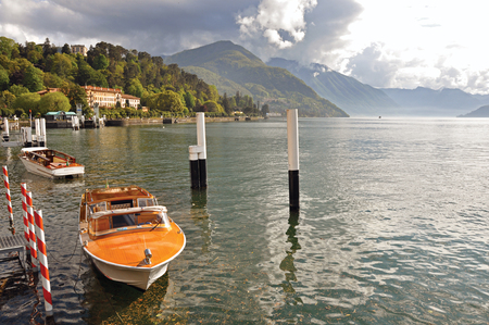 Como, Italy - May 06, 2013. View of Lake Como in a sunny day with motorboat and harbor in Bellagio, a charming village between the lake and the mountains of Alps. Lombardy region, northern Italyのeditorial素材