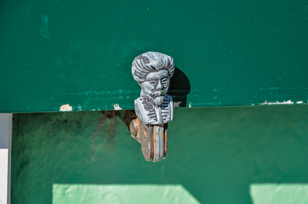 Close-up of blind catch made in iron, with face shape on sunny day in Burano, a gracious little town full of canals, near Venice. Located in the Veneto region, northern Italyの写真素材