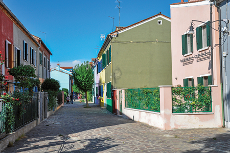 Burano, Italy - May 08, 2013. Overview of colorful terraced houses in an alley on sunny day in Burano, a gracious little town full of canals, near Venice. Located in the Veneto region, northern Italyのeditorial素材