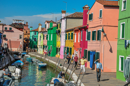 Burano, Italy - May 08, 2013. Colorful buildings, tower, people and boats in front of the canal at Burano, a gracious little town full of canals, near Venice. In the Veneto region, northern Italyのeditorial素材