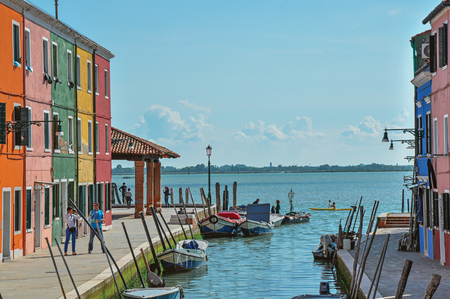 Burano, Italy - May 08, 2013. View of colorful buildings, people and boats in front of the canal at Burano, a gracious little town full of canals, near Venice. In the Veneto region, northern Italyのeditorial素材