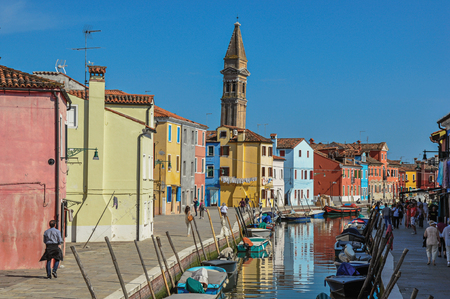 Burano, Italy - May 08, 2013. Colorful buildings, tower, people and boats in front of the canal at Burano, a gracious little town full of canals, near Venice. In the Veneto region, northern Italyのeditorial素材