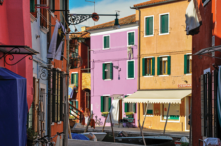 Burano, Italy - May 08, 2013. View of colorful buildings, people and boats in front of the canal at Burano, a gracious little town full of canals, near Venice. In the Veneto region, northern Italyのeditorial素材
