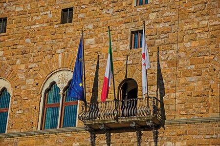 Close-up of flags on a balcony in front of the Palazzo Vecchio at sunset. In the city of Florence, the famous and amazing capital of the Italian Renaissance. In the Tuscany region. Retouched photoのeditorial素材