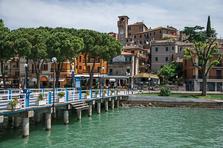 Passignano sul Trasimeno, Italy - May 15, 2013. View of the village and its harbor on the shores of Lake Trasimeno, a quiet and picturesque lake near Perugia. Located in Umbria region, central Italyのeditorial素材