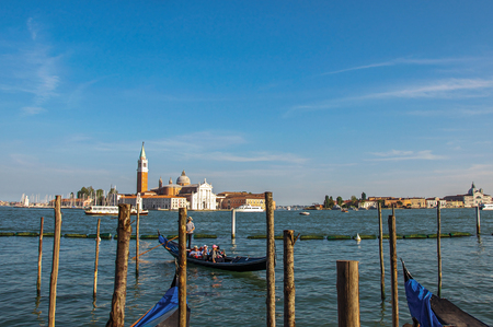 Venice, Italy - May 09, 2013. Panoramic view of Venice lagoon with pier and gondola in front and buildings behind. At the city of Venice, the historic and amazing marine city. Veneto regionのeditorial素材