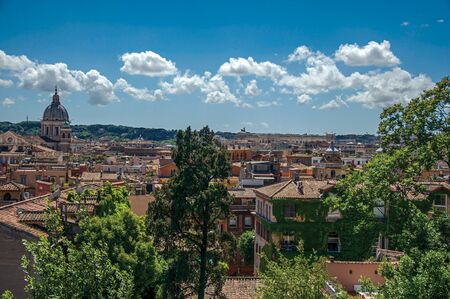 Overview of cathedrals domes and roofs of buildings on a sunny day in Rome, the incredible city of the Ancient Era, known as "The Eternal City". Located in the Lazio region, central Italyの写真素材