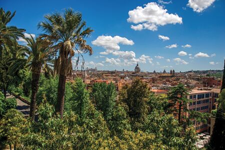 Overview of cathedrals domes, monuments and roofs of buildings on a sunny day in Rome, the incredible city of the Ancient Era, known asの写真素材