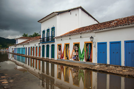 Paraty, Brazil - January 23, 2015. View of shops in old houses at alley with flooded stone walkway in Paraty, the historic town totally preserved in Rio de Janeiro State coast, southwestern Brazilのeditorial素材