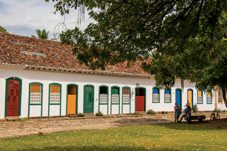 Paraty, Brazil - January 26, 2015. Overview of cobblestone street with old houses and big tree in Paraty, an amazing and historic town in Rio de Janeiro State coast, southwestern Brazilのeditorial素材