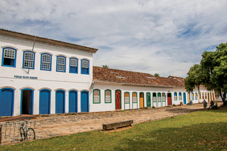 Paraty, Brazil - January 26, 2015. Overview of cobblestone street with old houses and big tree in Paraty, an amazing and historic town in Rio de Janeiro State coast, southwestern Brazilのeditorial素材