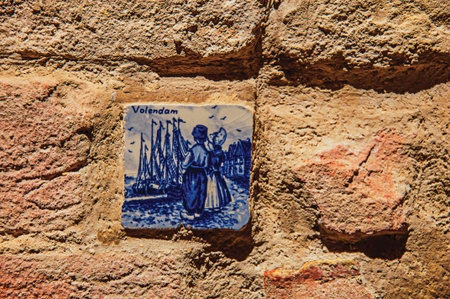 Close-up of ceramic tile attached to the wall in Colle di Val d'Elsa. The graceful village with its historic center preserved and known by its crystal production. Tuscany region. Retouched photoの写真素材