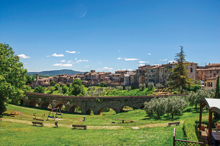 View of Colle di Val d'Elsa town with bridge and vegetation at the front. The graceful village with its historic center preserved and known by its crystal production. Located in the Tuscany regionの写真素材