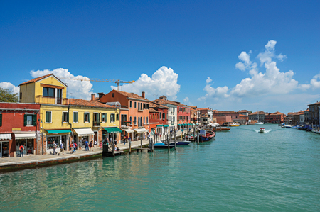 Murano, Italy - May 08, 2013. View of buildings, in front of canal, with people and boats in Murano, a nice little town on top of islands near Venice. Located in the Veneto region, northern Italyのeditorial素材