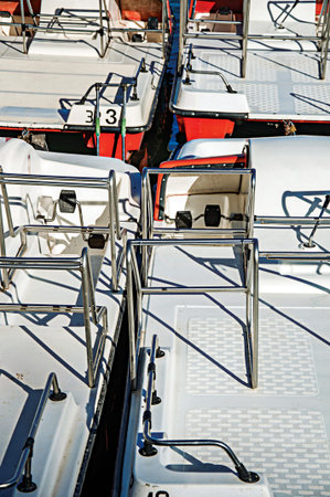 Close-up of paddle boats moored in a pier at the Annecy lake. Located in the department of...