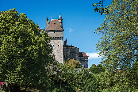 Partial view of Castle of Menthon-Saint-Bernard with trees and blue sky, near the Lake of Annecy. Department of Haute-Savoie, Auvergne-Rhone-Alpes region, south-eastern France.のeditorial素材