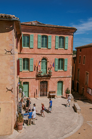 Roussillon, France - July 03, 2016. Traditional colorful houses in ocher and people in the historic city center of Roussillon. Located in the Vaucluse department, Provence region, southeastern Franceのeditorial素材