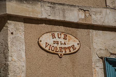 Close-up of street sign with sunny blue sky in the city center of Nimes. Located in the Gard...
