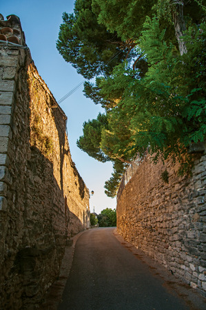 View of traditional stone houses and walls on a street at sunset, in Chateauneuf-de-Gadagne. Located in the Vaucluse department, Provence-Alpes-Côte d'Azur region, southeastern Franceの写真素材