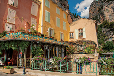 Moustiers-Sainte-Marie, France - July 08, 2016. Restaurant with flowers and cliffs in the village of Moustiers-Sainte-Marie. Alpes-de-Haute-Provence department. Provence region, southeastern Franceのeditorial素材