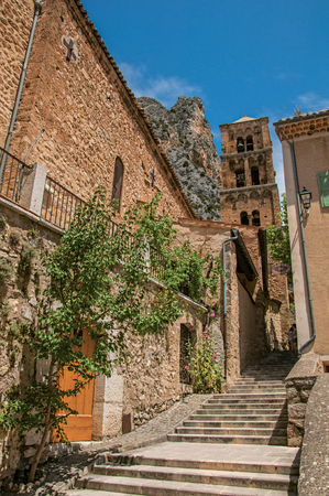 View of alleyway with staircase, steeple and cliff in the background, in the charming village of Moustiers-Sainte-Marie. In the Alpes-de-Haute-Provence department, Provence region, southeastern Franceのeditorial素材