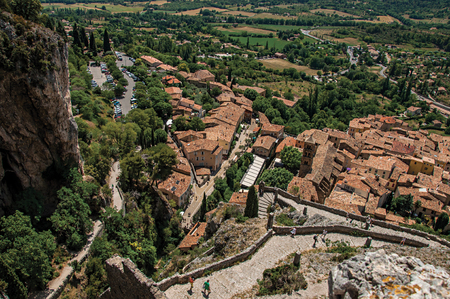 View of stone staircase, roofs and belfry under sunny blue sky in the charming village of Moustiers-Sainte-Marie. In the Alpes-de-Haute-Provence department, Provence region, southeastern Franceの写真素材
