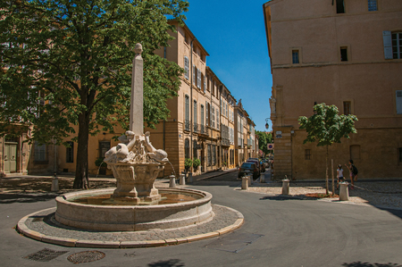 Aix-en-Provence, France - July 09, 2016. Street with buildings and fountain in sunny afternoon in Aix-en-Provence, a pleasant and lively town in the countryside. Provence region, southeastern Franceのeditorial素材