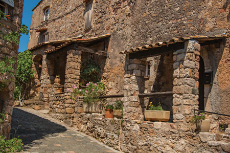 View of old stone houses in alley under blue sky, at the gorgeous medieval hamlet of Les Arcs-sur-Argens, near Draguignan. Located in the Provence region, Var department, southeastern Franceのeditorial素材