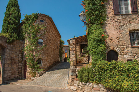 Les Arcs-sur-Argens, France - July 10, 2016. Old stone houses in alley under blue sky, at the gorgeous medieval hamlet of Les Arcs-sur-Argens. Provence region, Var department, southeastern Franceのeditorial素材