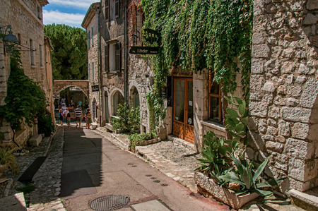 Saint-Paul-de-Vence, France - July 13, 2016. Alley with stone houses and shops in the Saint-Paul-de-Vence village, stunning medieval town completely preserved. In Provence region, southeastern Franceのeditorial素材
