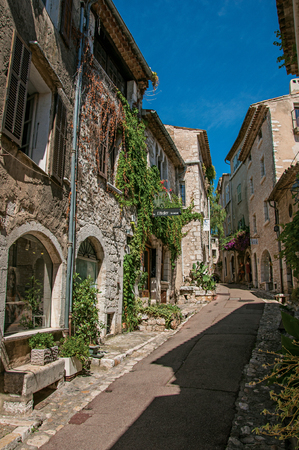 Saint-Paul-de-Vence, France - July 13, 2016. Alley with stone houses and shops in the Saint-Paul-de-Vence village, stunning medieval town completely preserved. In Provence region, southeastern Franceのeditorial素材