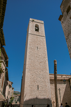 View of stone steeple tower next to church in Saint-Paul-de-Vence, a lovely well preserved medieval hamlet near Nice. In Alpes-Maritimes department, Provence region, southeastern Franceの写真素材