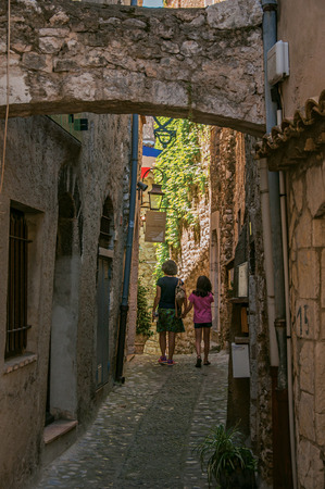 Saint-Paul-de-Vence, France - July 13, 2016. Mother and little girl in alley of stones in Saint-Paul-de-Vence, stunning medieval town completely preserved. In Provence region, southeastern Franceのeditorial素材