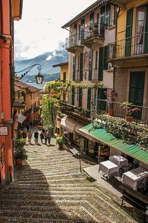 Como, Italy - May 06, 2013. View of alley in hillside, buildings with bindweed and Lake Como in Bellagio, a charming village between the lake and the mountains of Alps. Lombardy region, northern Italyのeditorial素材