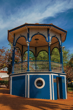 Sao Manuel, southeast Brazil - September 09, 2017. Close-up of old colorful gazebo with verdant garden in sunny day at San Manuel. A cute little town in the countryside of Sao Paulo State.の写真素材