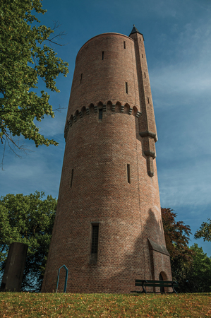 Park with path, brick tower next to it and blue sky, early in the morning at Bruges. With many canals and old buildings, this graceful town is a World Heritage Site of Unesco. Northwestern Belgium.のeditorial素材