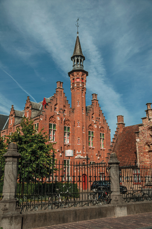 Iron fence and brick building in typical architecture of the Flanders region in Bruges. With many canals and old buildings, this graceful town is a World Heritage Site of . Northwestern Belgium.の写真素材