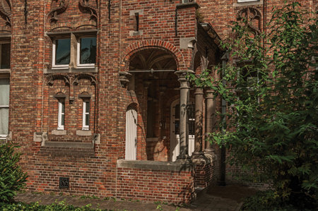 Brick facade of house in typical style of the Flanders's region and blue sky in Bruges. With many canals and old buildings, this graceful town is a World Heritage Site of Unesco. Northwestern Belgium.のeditorial素材