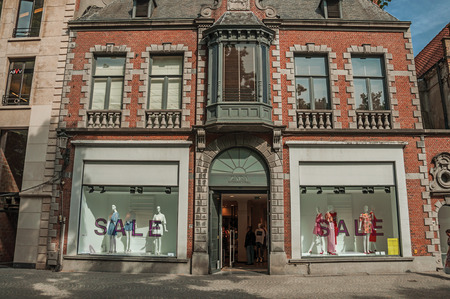 Bruges, Belgium - July 05, 2017. Street with people, brick houses and shops in Bruges. With many canals and old buildings, this graceful town is a World Heritage Site of Unesco. Northwestern Belgium.のeditorial素材