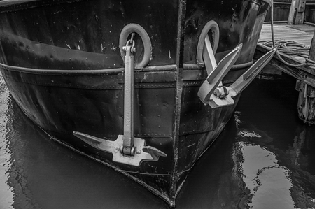 Close-up of a rusty boat moored in port at Amsterdam. Famous for its huge cultural activity, graceful canals and bridges. Northern Netherlands. Black and white photo.のeditorial素材