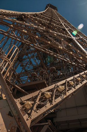 Perspective view of the iron structure from the top of Eiffel Tower with sunshine in Paris. Known as...