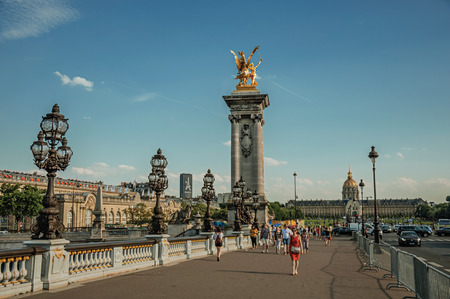 Paris, France - July 07, 2017. People on elegant Alexandre III bridge over the Seine River in Paris. Known as the "City of Light", it is one of the world's most awesome cultural centers. Northern France.のeditorial素材