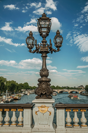 Close-up of the lavishly decorated lamp on the Alexandre III bridge at the Seine river in Paris. Known as the "City of Light", it is one of the world's most awesome cultural centers. Northern Franceの写真素材