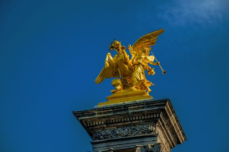 Golden statue adorning the Alexandre III bridge over the Seine River in Paris. Known as the "City of Light", it is one of the most impressive cultural centers in the world. Northern France. Retouched photoの写真素材