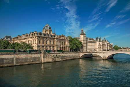 Bridge over the Seine River and the Conciergerie building with sunny blue sky at Paris. Known as the "City of Light", it is one of the most impressive cultural centers in the world. Northern France.のeditorial素材