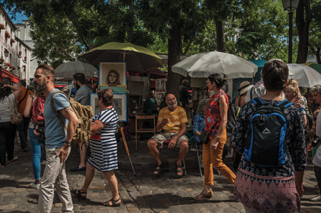 Paris, France - July 08, 2017. People and artists at the fair art of Montmartre in Paris. Known as the "City of Light", it is one of the most impressive cultural centers in the world. Northern France.のeditorial素材