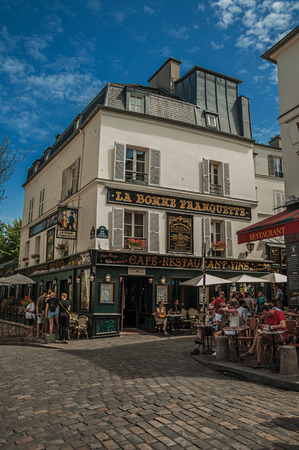 Paris, France - July 08, 2017. People having fun in Montmartre's restaurant in sunny day at Paris. Known as the "City of Light", it is one of the most impressive cultural centers in the world. Northern France.のeditorial素材