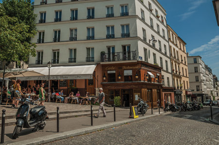 Paris, France - July 08, 2017. People, buildings and blue sky on the street of Montmartre at Paris. Known as the "City of Light", it is one of the most impressive cultural centers in the world. Northern France.のeditorial素材